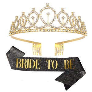 Detailed macro view of sparkling gold rhinestone crown and black glitter Bride To Be sash set