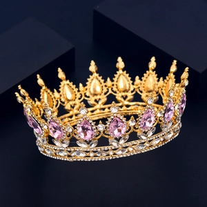 Detail of luxury bridal crown featuring pink teardrop crystals and gold hollow carvings