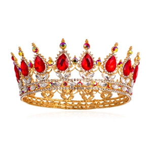 Close-up of golden bridal tiara with red pear-shaped crystals and sparkling rhinestones