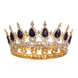 Detail of luxury baroque crown with purple crystals and gold alloy filigree texture