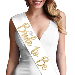 Close-up of white satin Bride to Be sash with elegant rose gold glitter lettering