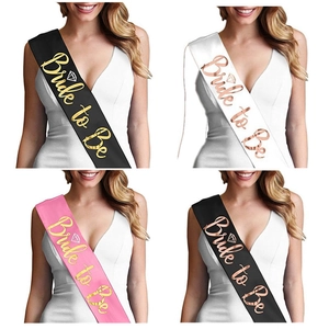 Close-up of Bride to Be satin sashes in black, white, and pink with metallic lettering