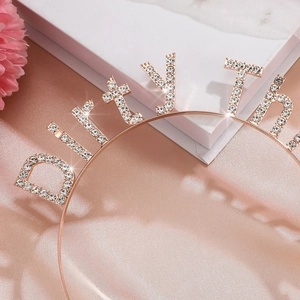 Close-up of sparkling rose gold Dirty Thirty rhinestone headband for 30th birthday party