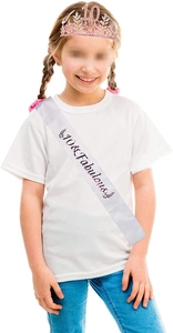 Close-up of sparkling pink rhinestone 10th birthday tiara and satin sash with golden lettering