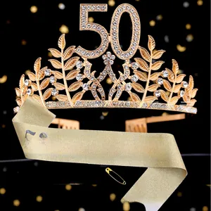 Close-up of sparkling gold rhinestone 50th birthday crown and glittery sash set
