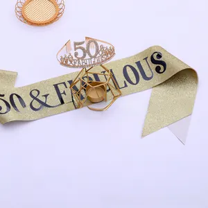 Macro shot of 50th birthday gold rhinestone crown and 50 & FABULOUS glitter sash kit