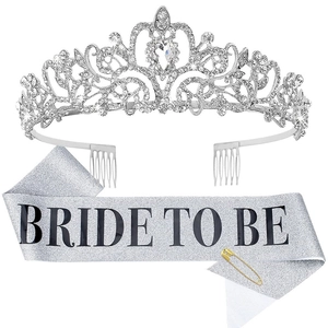 Close-up of sparkling silver rhinestone crown and glitter Bride To Be sash for parties