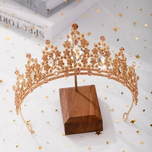 Detail of golden Baroque bridal tiara featuring amber rhinestones and waterdrop crystals