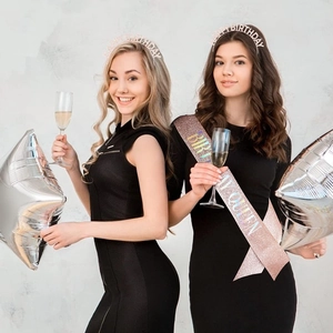 Close-up of birthday crown headband and glitter sash set for party celebrations