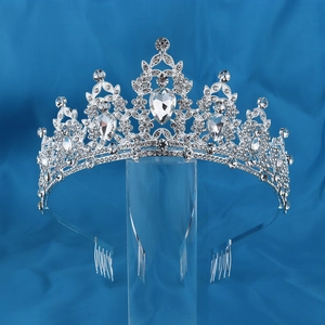 Detailed close-up of a silver rhinestone crown with water drop gems and hair comb attachment