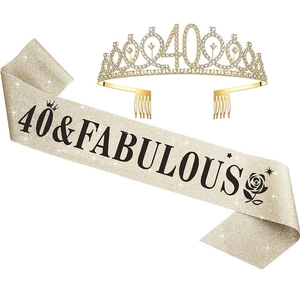 Detail of 40th birthday set featuring a gold rhinestone crown and sparkly champagne sash