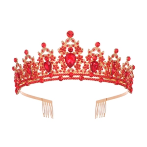 Detail of red teardrop gemstones and small diamonds set in a baroque golden crown base