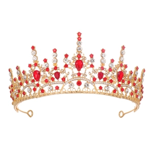 Golden bridal crown with red rhinestones and crystal accents on white background