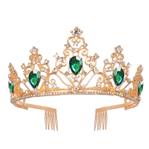 Detail of luxury bridal crown featuring green teardrop crystals and gold metal frame