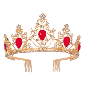 Detail of luxury gold tiara with large red teardrop crystals and clear rhinestones