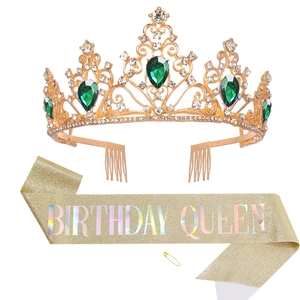 Detail of gold birthday queen tiara with emerald crystals and matching glitter sash