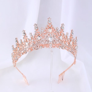 Close-up of rose gold bridal tiara with sparkling crystal rhinestones and metal hair comb