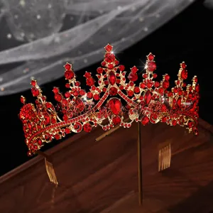 Detailed view of luxury gold bridal tiara with red rhinestones and teardrop rubies