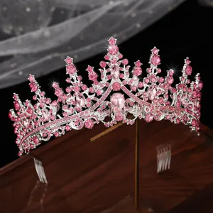 Detailed macro view of a silver Baroque tiara featuring pink rhinestones on a metal stand