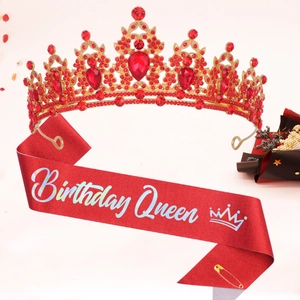Detailed shot of a red Birthday Queen sash and crown with sparkling ruby-colored rhinestones