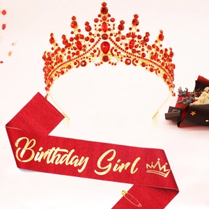 Detail of red glitter sash with gold Birthday Girl text and matching crystal crown