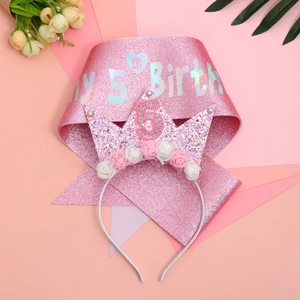 Close-up of pink 5th birthday sash with holographic text and floral crown headband