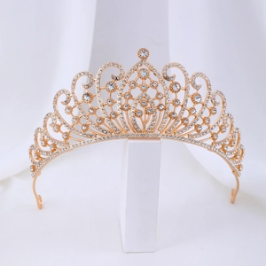 Detail of gold crystal crown with intricate scrollwork and sparkling rhinestones