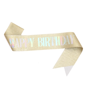Close-up of golden glitter sash with laser engraved HAPPY BIRTHDAY letters for parties