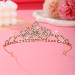 Golden flower crown for kids with pink and white rhinestones on a soft pink background