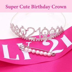 Detail of 21st birthday silver rhinestone crown with rose pink satin sash and pearl pin