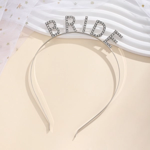 Macro detail of silver alloy headband with BRIDE lettering and shimmering rhinestones