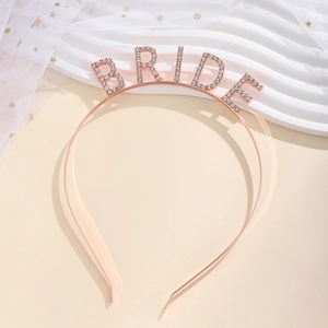 Close-up of rose gold BRIDE headband with sparkling rhinestones for wedding team