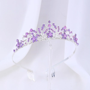 Detailed view of silver bridal crown with purple rhinestones and plum blossom swirl design