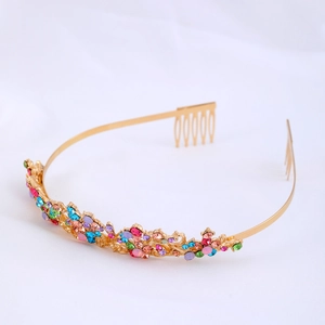 Close-up of colorful rhinestones on gold bridal crown with side combs for secure fit
