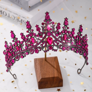 Macro view of vintage black alloy crown featuring pink rhinestones and teardrop crystals