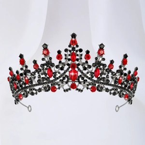 Detail of vintage black alloy crown with red teardrop stones and dark crystal inlays