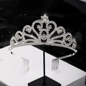 Macro view of silver bridal tiara featuring heart-shaped crystals and intricate floral patterns