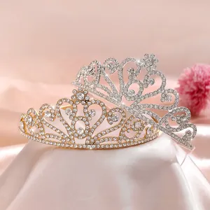 Detailed view of silver and gold crystal crowns with heart and vine filigree patterns
