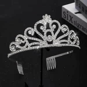 Detail of silver alloy crown with sparkling rhinestones and integrated hair combs