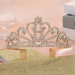 Detailed close-up of golden heart tiara crown with white rhinestones and hair combs