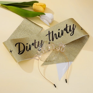 Close-up of golden glitter sash with Dirty Thirty text and rhinestone crown headband