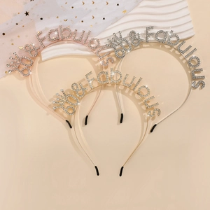 Detailed view of three 60 & Fabulous rhinestone headbands in gold, silver and rose gold