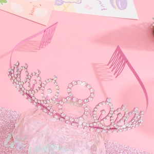 Detailed view of pink sparkling crown headband with inlaid rhinestones and hair combs