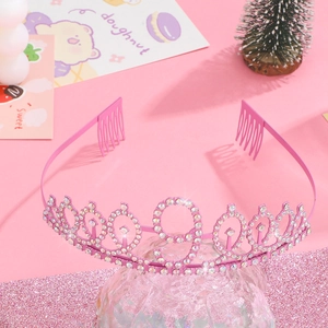 Detailed view of pink metal birthday tiara with rhinestones and number 9 motif