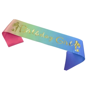 Detail of colorful mermaid birthday girl sash with gold foil text on satin fabric