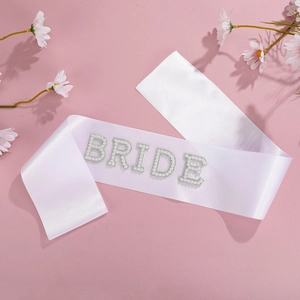 Detail of satin Bride sash featuring elegant 3D white pearl lettering for bridal parties