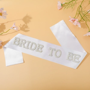 Close-up of Bride to Be satin sash with pearl and rhinestone lettering for bridal shower