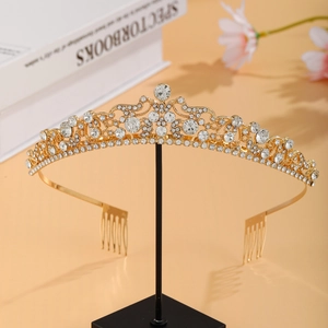 Detail of a luxury gold bridal tiara with sparkling rhinestones and side combs for secure fit