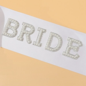 White satin bride sash with pearl and rhinestone lettering for bachelorette party