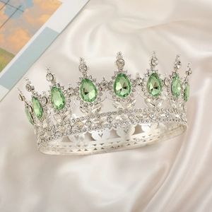 Close-up of bridal crown featuring green pear-cut crystals and silver rhinestone details